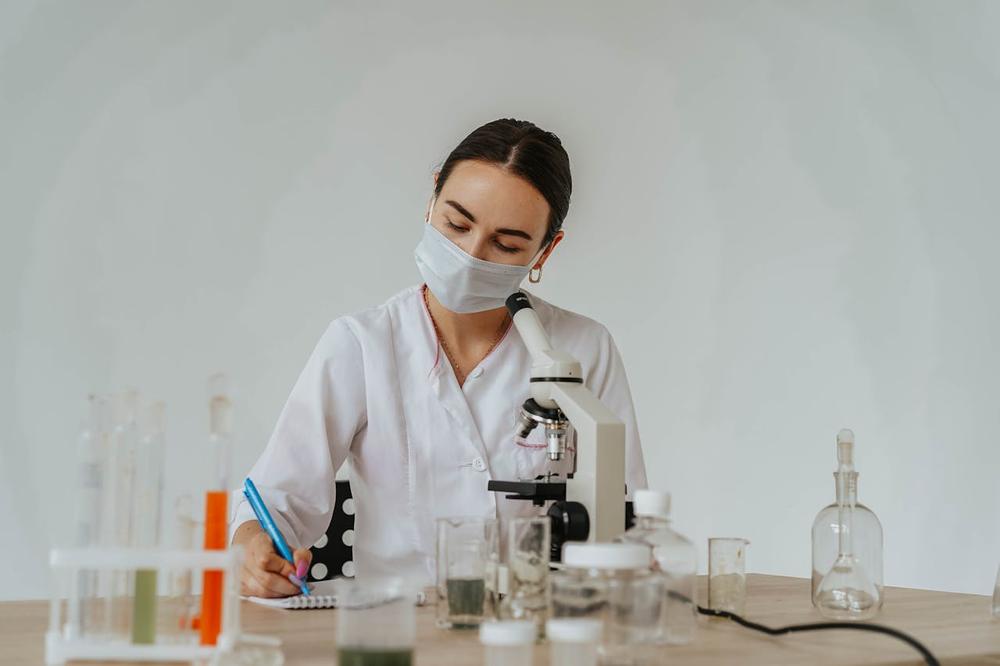 A doctor in a lab wearing a mask which shows what to expect when you study medicine