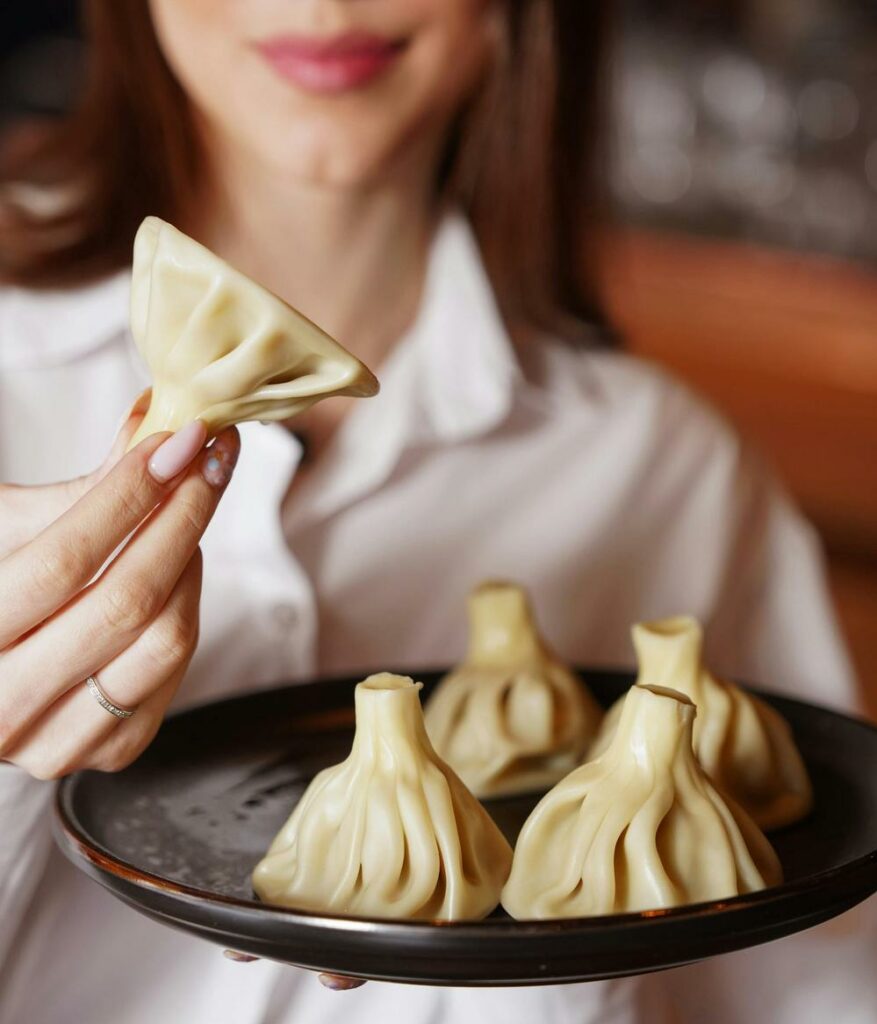 Woman Holding a Plate with Georgian Khinkali Traditional Food