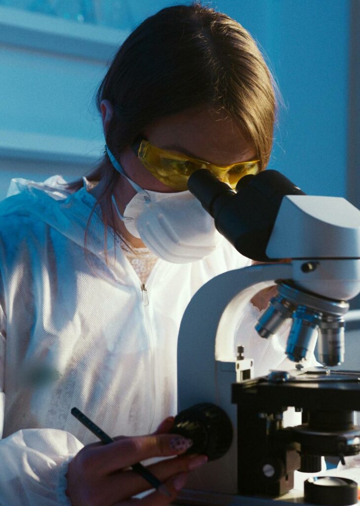 Photo Of Woman Looking Through Microscope