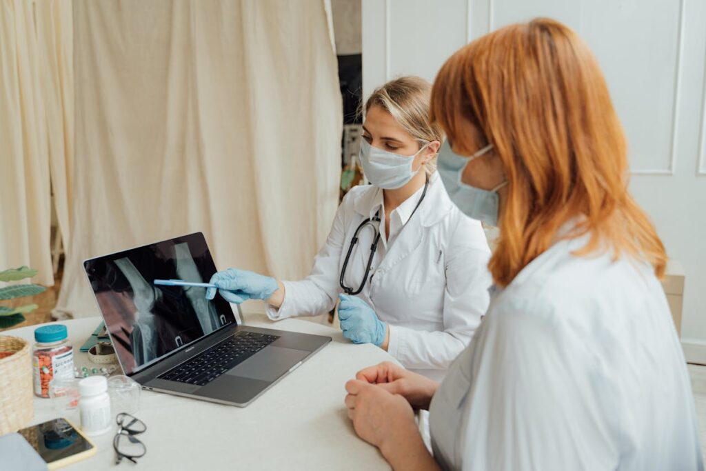 Doctors Examining an X Ray Image on a Laptop Doctors Examining an X Ray Image on a Laptop
